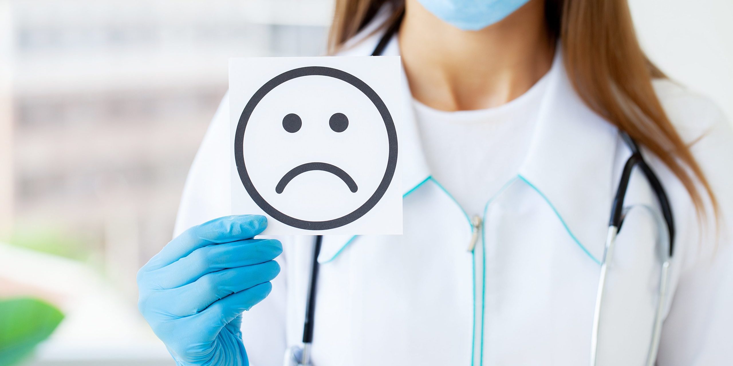 doctor-holding-a-cards-with-symbol-sad-smile-2023-11-27-04-58-21-utc-min