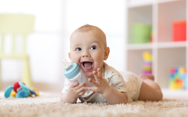 cute-baby-boy-drinking-bottle-kid-shutterstock_1021060435