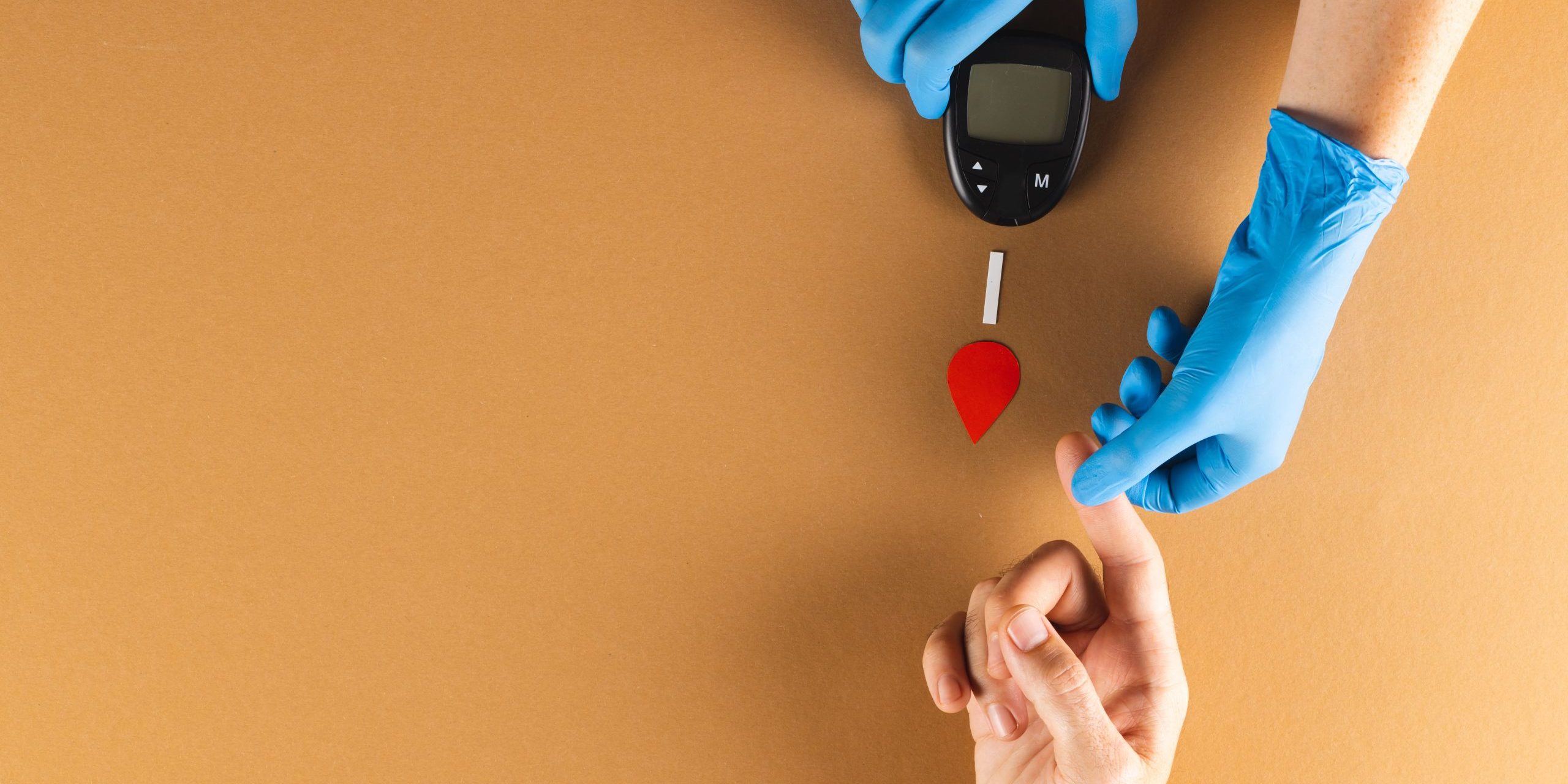 hands-of-gloved-doctor-with-glucometer-taking-bloo-2023-11-27-05-33-15-utc-min