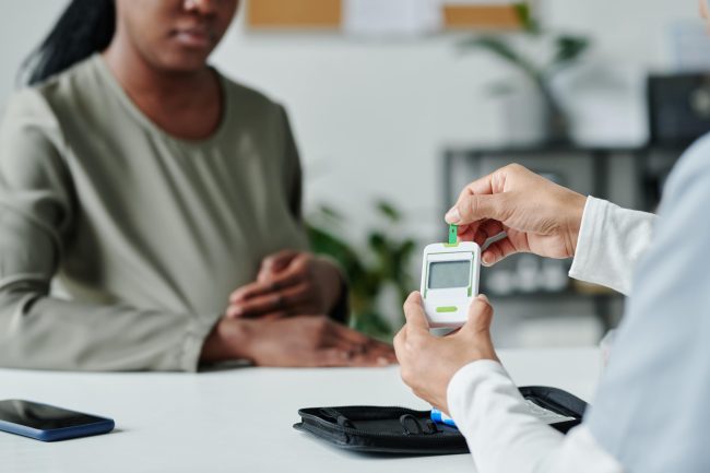 unrecognizable-clinician-with-glucometer-2024-07-27-01-44-48-utc-min